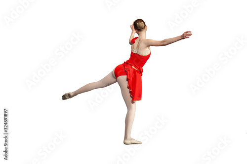 Girl ballerina performs a movement. The girl in the dance. Choreography class. Red dress. Dancer's clothes. Dress and tights. Frame from the back. Graceful dance movement.