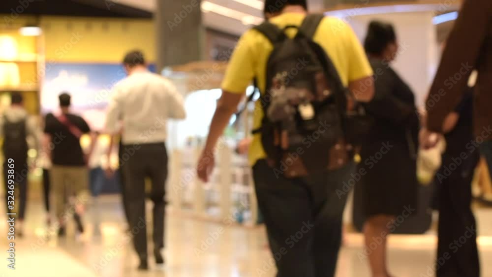 Blurred Background, Many people walk inside the mall exhibition store. Blurred Background, Many people walk inside the mall exhibition store.