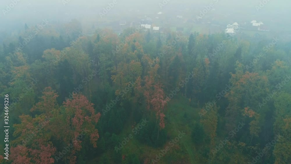 Aerial view of autumn forest covering slowly by white blanket of thick clouds. Aerial view of autumn forest covering slowly by white blanket of thick clouds.