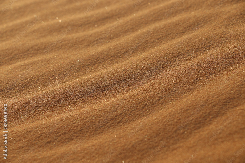 sand texture - background of desert sand dunes. Beautiful structures of sandy dunes. sand with wave from wind in desert - Close up sand texture - background of desert sand dunes. Beautiful structures of sandy dunes. sand with wave from wind in desert - Close up