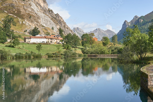 A mountain houses reflected in a lake in Somiedo  Asturias  Spain 