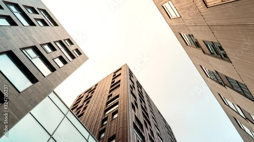 Timelapse of clouds passing by modern office buildings