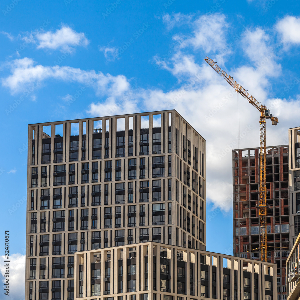 Construction of a modern residential complex. The construction of a multi-story building. cargo crane Construction of a modern residential complex. The construction of a multi-story building. cargo crane