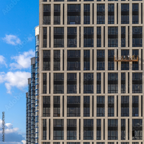 Modern high-rise buildings opposite a clear blue sky in perspective. The concept of urban development.