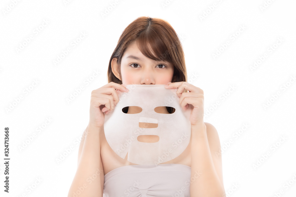 Young Asian girl with facial mask looking at camera over white background. Cosmetic procedure. Beauty spa and cosmetology. Young Asian girl with facial mask looking at camera over white background. Cosmetic procedure. Beauty spa and cosmetology.