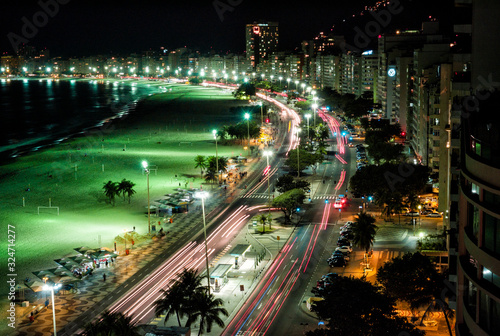Fototapeta Naklejka Na Ścianę i Meble -  Copacabana long exposure with trailing car lights in Rio de Janeiro Brazil