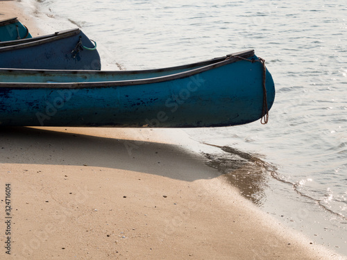 Canoes on a sandy beach at sunset - Whale Island, Vietnam photo