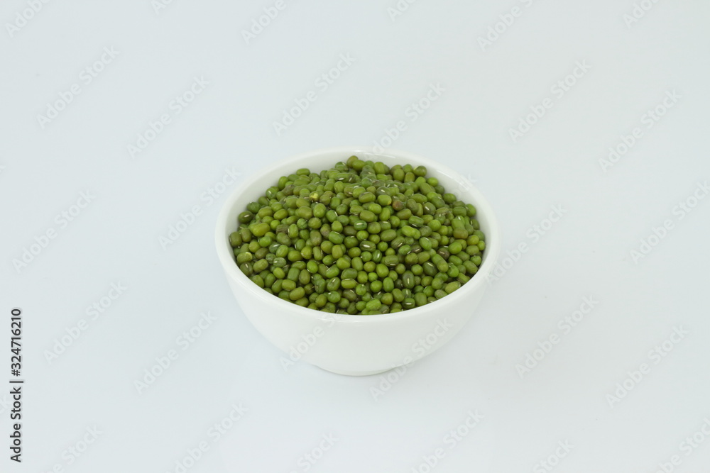 dry mung beans in white ceramic bowl on white background. protiens. for packaging. advertising. editorial dry mung beans in white ceramic bowl on white background. protiens. for packaging. advertising. editorial