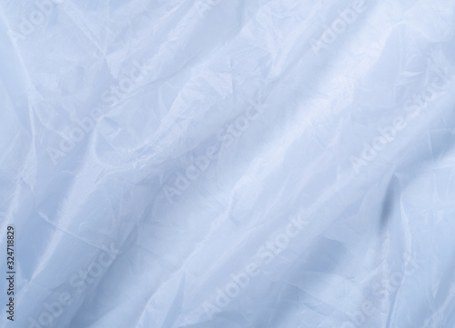 Blue clean sheet, close up view. Smooth blue textile, an abstract background. Texture of blue fabric. Background for wallpapers and banners