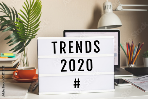 Trends 2020 concepts with text on cinema light box on worktable.business vision