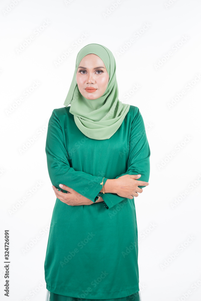 Beautiful female model in modern kurung and hijab, a modern lifestyle apparel for Muslim women isolated on white background. Beauty and hijab fashion concept. Half length portrait Beautiful female model in modern kurung and hijab, a modern lifestyle apparel for Muslim women isolated on white background. Beauty and hijab fashion concept. Half length portrait