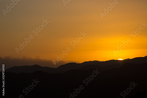 dramatic colourful sunset image in the caribbean mountains of the dominican republic.