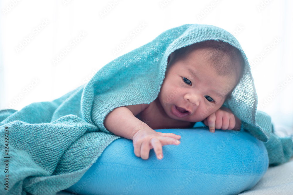 Newborn baby and blue towel in white background Newborn baby and blue towel in white background