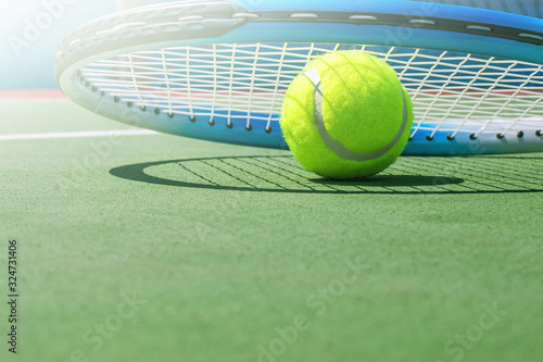 Tennis racket and tennis ball on court. © SK imagine