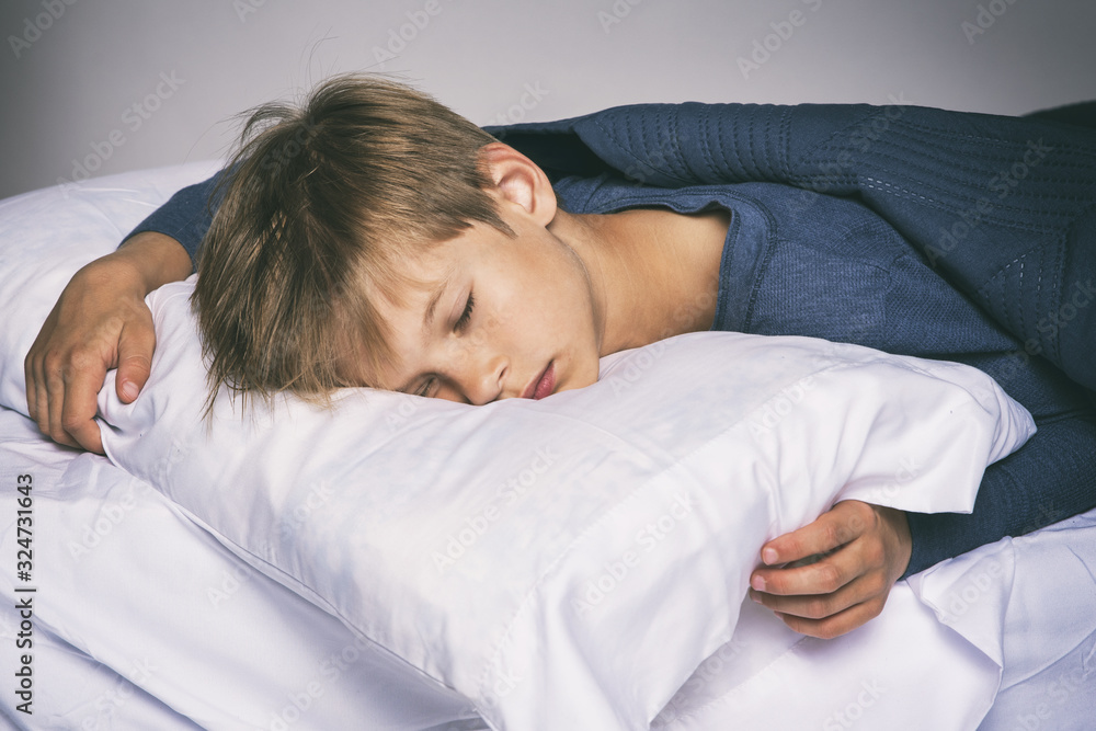 Sleeping boy in bed with pillow and blanket Sleeping boy in bed with pillow and blanket