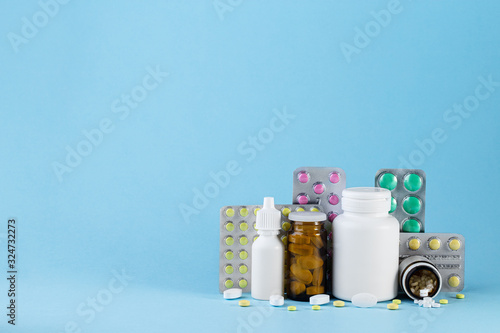 Pharmaceutical medicament, cure in container for health. Pharmacy theme, capsule pills with medicine antibiotic in packages. Blister packs full of multicolored pills. Medicine concept
