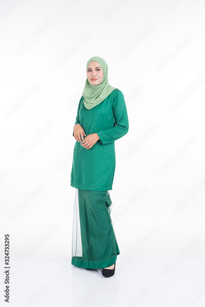 Beautiful female model in modern kurung and hijab, a modern lifestyle apparel for Muslim women isolated on white background. Beauty and hijab fashion concept. Full length portrait