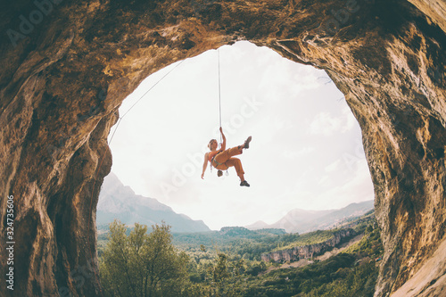 Rock climber hanging on a rope.