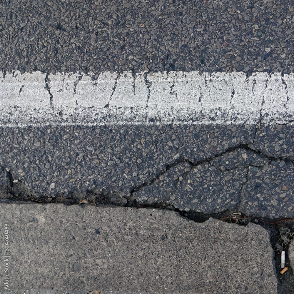 Obraz premium Cracked Asphalt with White Stripe Texture