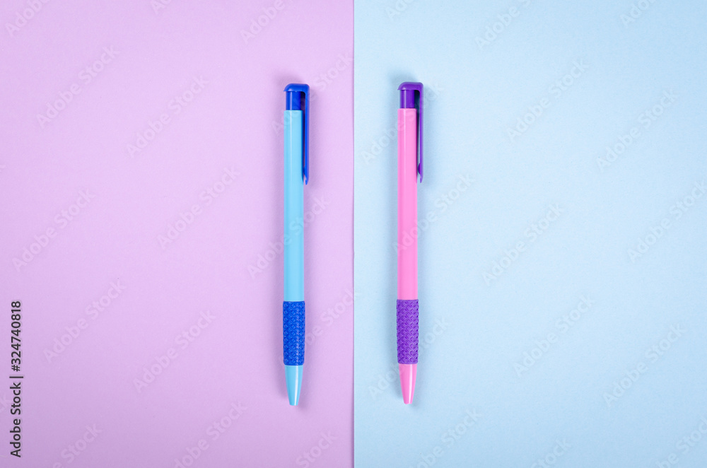 Different colored pens, school ballpoint on purple background composition. Different colored pens, school ballpoint on purple background composition.