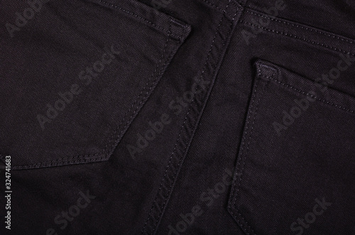 Black cotton jeans texture background with copy space.