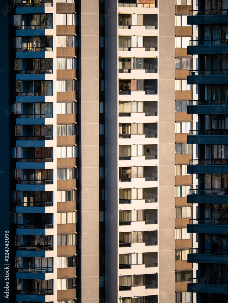 Facade of residential high-rise towers on bright sunny day