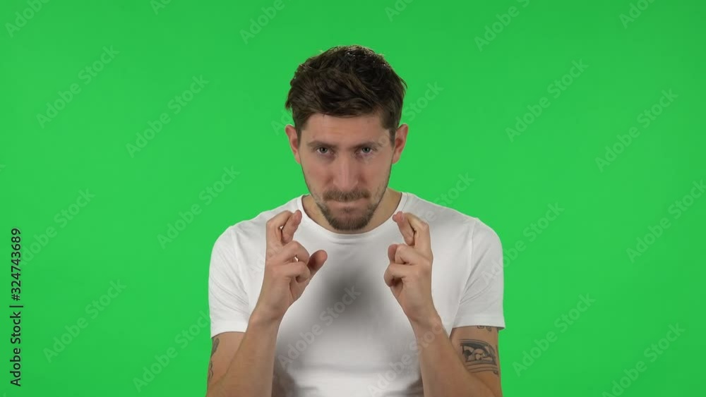 Portrait of confident guy is looking at the camera with excitement, then celebrating his victory triumph. Green screen Portrait of confident guy is looking at the camera with excitement, then celebrating his victory triumph. Green screen