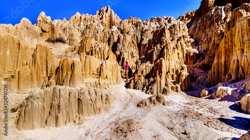 Woman in the dramatic and unique patterns of Slot Canyons and Hoodoos caused by erosion of the soft volcanic Bentonite Clay in Cathedral Grove State Park in the Nevada Desert, United Sates