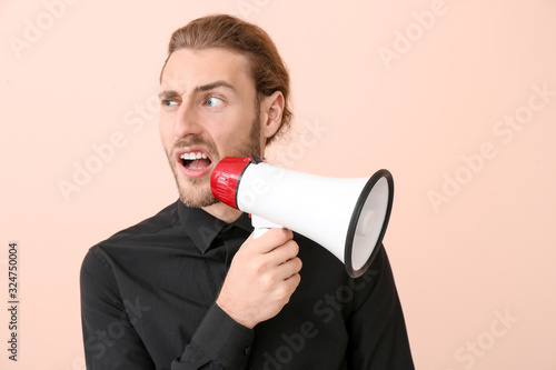 Young man with megaphone on...