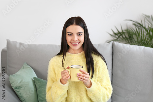 Smiling Young Woman Holding...