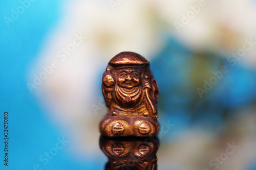 Ancient Netsuke The Japanese god of fortune and wealth Daikokuten. Daikoku is one of the seven gods of fortune. Macro soft focus © Victor Lauer