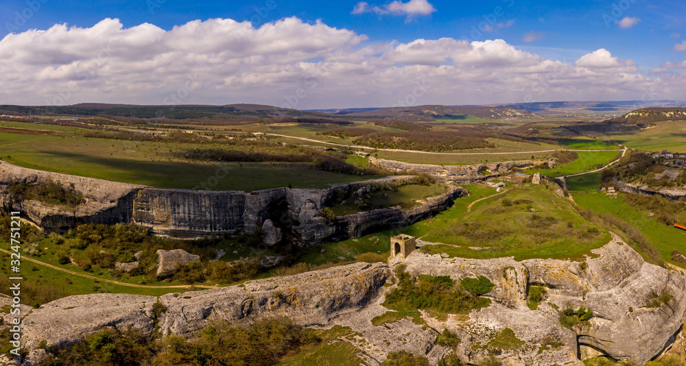 Maiden tower of the cave city Eski-Kermen, near the city of Bakhchisaray, Crimea. Panoramic aerial drone view