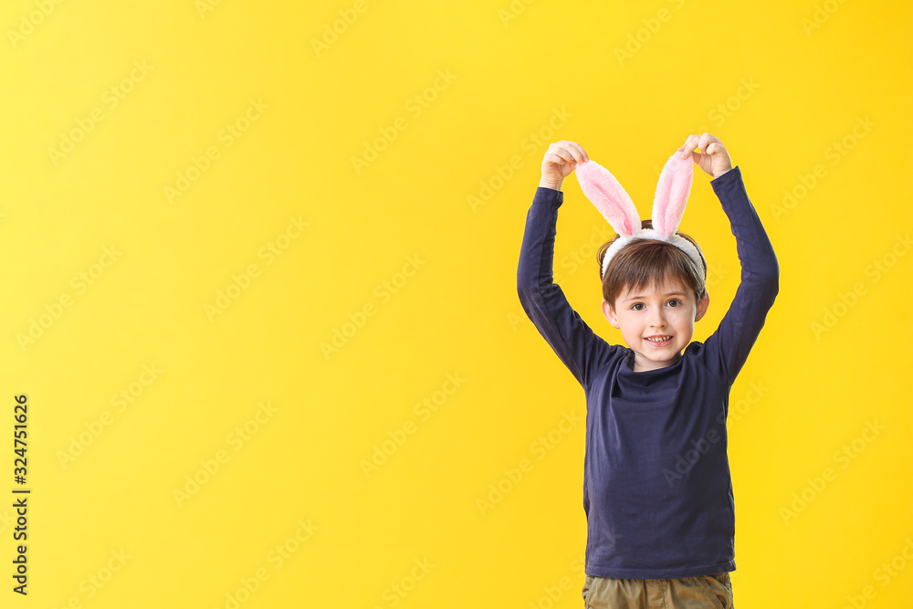 Little boy with bunny ears on color background Little boy with bunny ears on color background