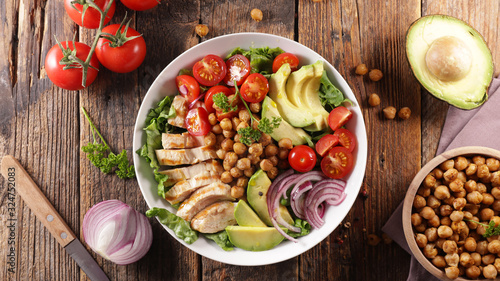 mixed vegetable salad with avocado, chicken, chickpea, onion and tomato