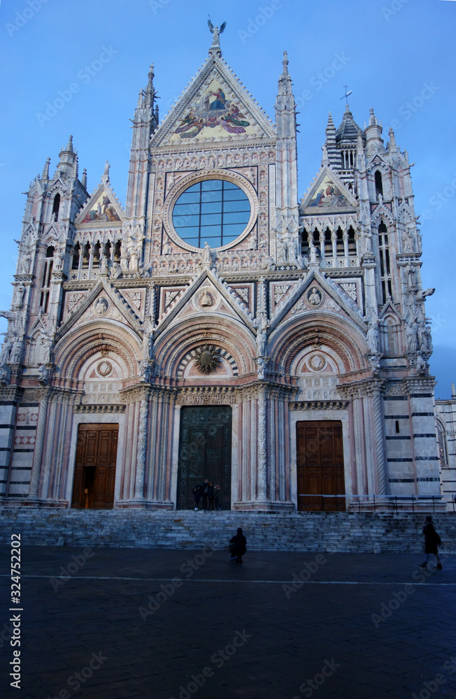 Exterior facade of the cathedral of Siena with the light of sunset.