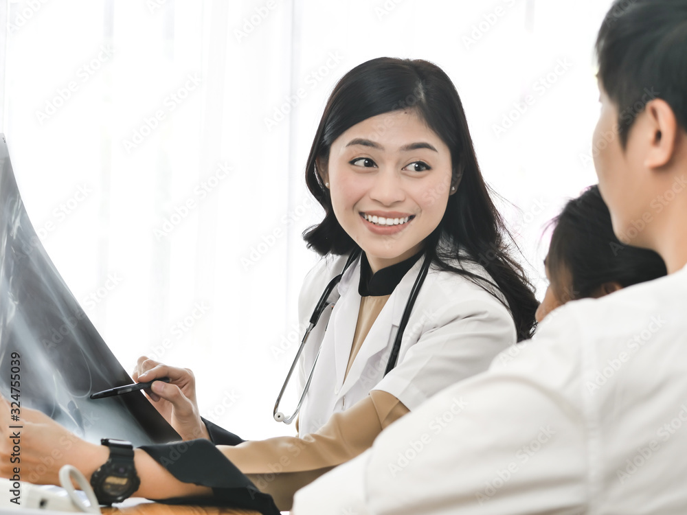 Asian doctor and child patient looking at xray film together. Asian doctor and child patient looking at xray film together.