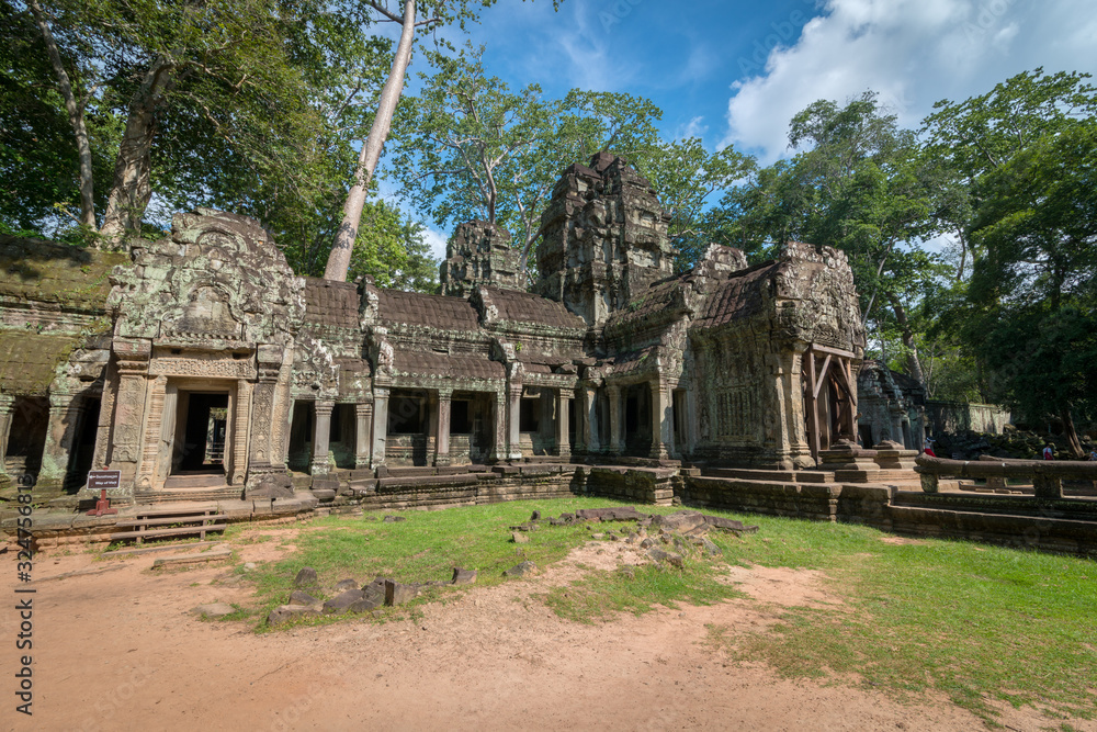 The scenery of an ancient stone door with clear blue sky, Ta Prohm temple ruins, Angkor, Cambodia. The scenery of an ancient stone door with clear blue sky, Ta Prohm temple ruins, Angkor, Cambodia.
