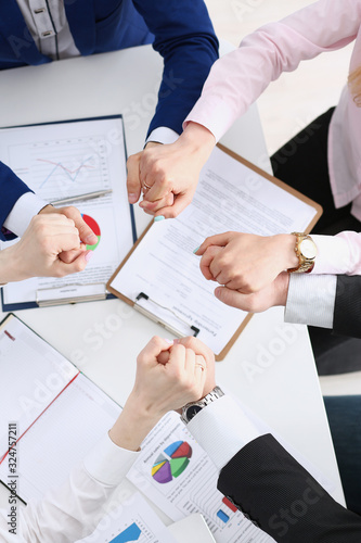 Group of people in suits crossed hands in pile for win closeup. White collar leadership high five cooperation initiative achievement corporate life style friendship dea, heap stack concept