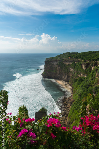 Beautiful scenery of Uluwatu cliff with beatiful clear sky and blue sea in Bali, Indonesia.