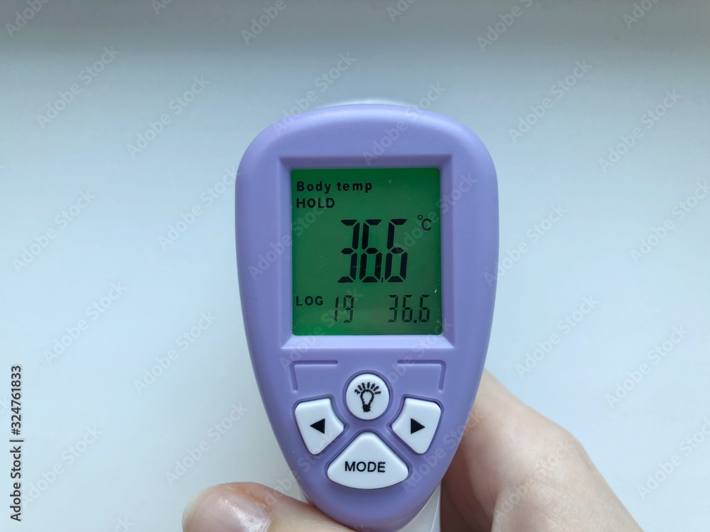 Electronic thermometer in hand. Is used to measure a patient's temperature in a hospital. Electronic thermometer in hand. Is used to measure a patient's temperature in a hospital.