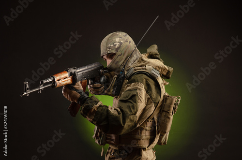 Картината върху платно soldier militia saboteur in military clothing with a Kalashnikov rifle on a dark