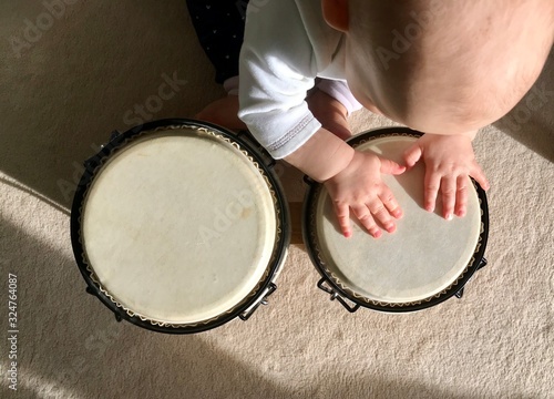 Baby is playing a cuban bongo photo