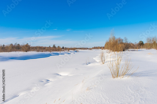 River swept by snow on a bright sunny day