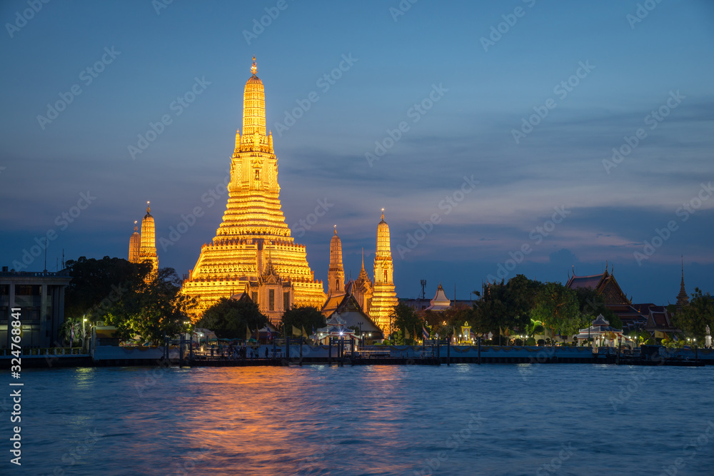 View of Wat Arun or locally known as Wat Chaeng glowing in twilight time in Bangkok, Thailand.