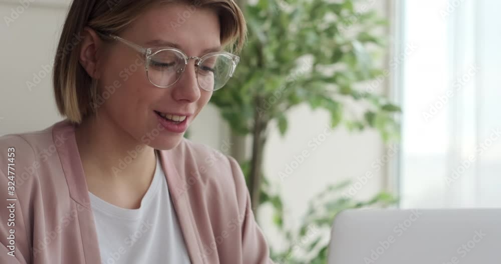 Businesswoman amazed on receiving good news online on laptop Businesswoman amazed on receiving good news online on laptop