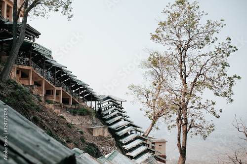 stairs with blue rooftops typical oriental with a tree in Myanmar