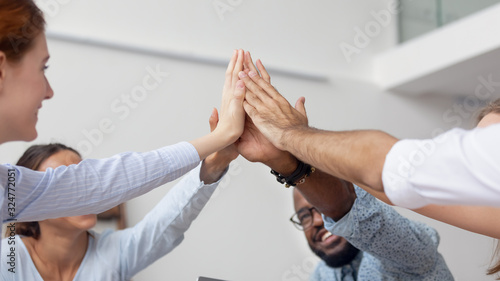 Wallpaper Mural Close up diverse employees team giving high five at company meeting Torontodigital.ca