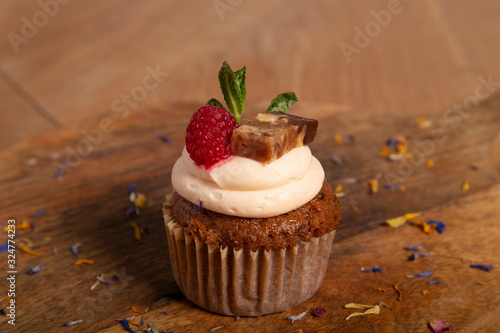 Close-up of healthy carrot muffin on wooden cutting board