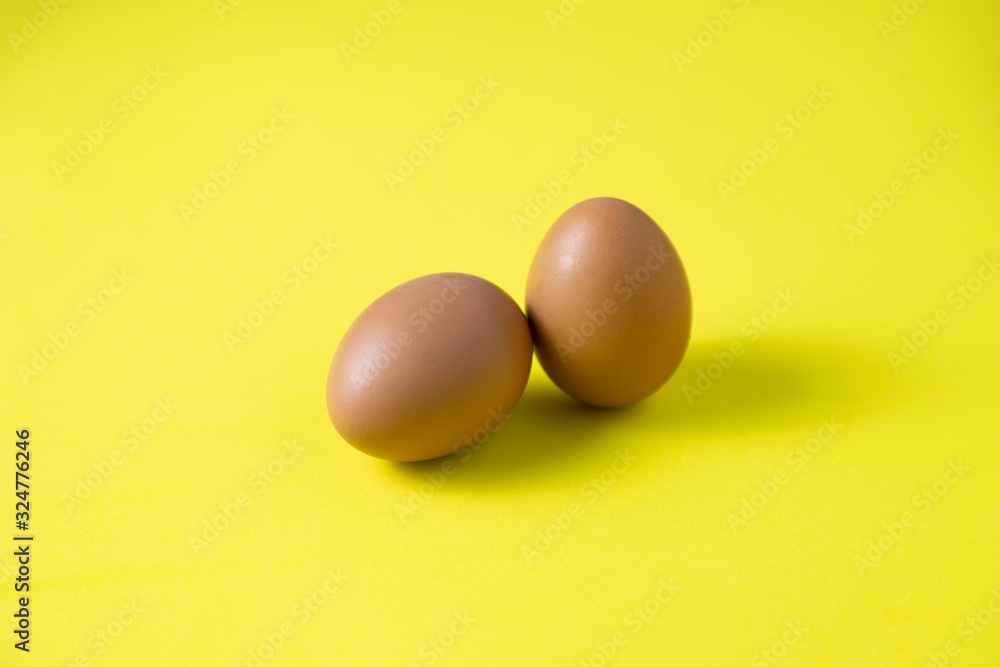 Chicken eggs are laid on yelow table Chicken eggs are laid on yelow table