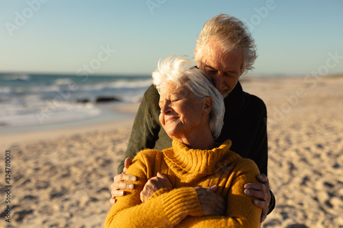 Old couple in love at the beach #324780003